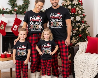May include: A family of four in matching black t-shirts and red and black plaid pyjama bottoms. The shirts say "Family Christmas 2025" with a Santa hat. A Christmas tree and fireplace are visible in the background.