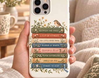 May include: A white smartphone case featuring a stack of seven colorful books decorated with floral illustrations and a small bird. The book spines are labeled with the text: Between the Pages, A Cup of Stories, The Little Book Nook, Wander in Words, Bloom & Read, Paper Daydreams, Shelf of Joy, and Stories to Keep.