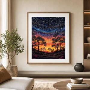May include: A framed wall art print depicting a landscape at night with silhouettes of trees against a vibrant sunset sky transitioning into a deep blue starry expanse filled with numerous white and gold dots representing stars.