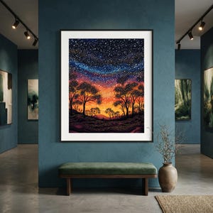 May include: A framed wall art print featuring a vibrant landscape at twilight. The scene depicts silhouettes of trees against a gradient sky transitioning from deep orange and yellow at the horizon to a dark blue starry night sky filled with white dots.