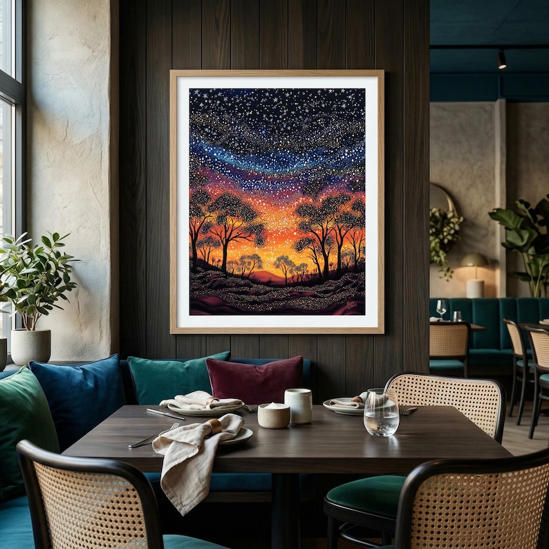 May include: A framed wall art print featuring a vibrant night sky filled with countless stars above a silhouette of trees and rolling hills. The horizon glows with warm orange and yellow hues, transitioning into a deep blue and purple starry sky.