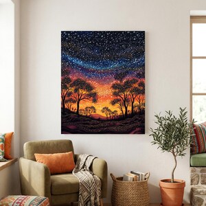 May include: A rectangular wall art print featuring a vibrant night sky filled with countless white stars above a silhouette of trees. The horizon transitions from a deep dark blue at the top to a warm orange and yellow glow near the ground.