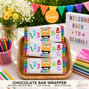 May include: Three rectangular chocolate bar wrappers featuring a yellow school bus graphic, the text "WELCOME BACK TO SCHOOL", numbers "123", and letters "ABC". The design includes a colorful crayon border on the left and right edges of each wrapper.
