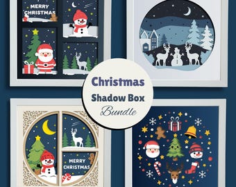 May include: A bundle of four white-framed Christmas shadow boxes. Each box features layered paper cutouts with festive designs, including Santa, snowmen, reindeer, and Christmas trees. The text "Merry Christmas" is visible on two of the boxes.