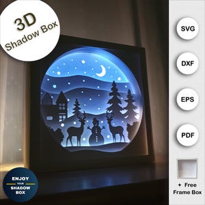 May include: A 3D shadow box featuring a winter scene. The scene includes a snowman, two deer, a house, and trees. The box is lit from behind, creating a glowing effect.