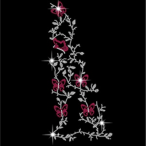 May include: A decorative design featuring a floral and butterfly motif. The design is composed of white and burgundy rhinestones arranged on a black background. The butterflies and flowers are accented with sparkling highlights.
