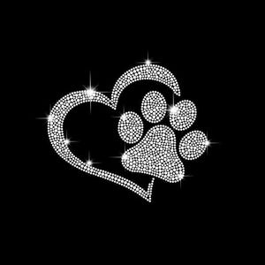 May include: A white rhinestone heart with a paw print inside. The heart and paw print are made of small, sparkling rhinestones.