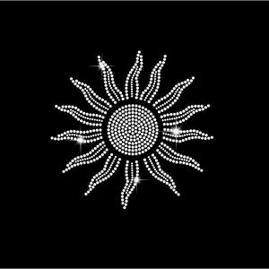 May include: A sun design created with white rhinestones on a black background. The central circular core is filled with dense white dots, surrounded by radiating wavy rays composed of smaller white rhinestones, creating a sparkling effect.