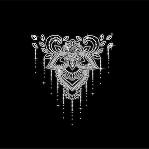 May include: A detailed, symmetrical design composed of numerous small, sparkling white dots, resembling a floral or ornamental pattern. The design is set against a solid black background, creating a striking contrast. The overall shape is reminiscent of a pendant or embellishment.