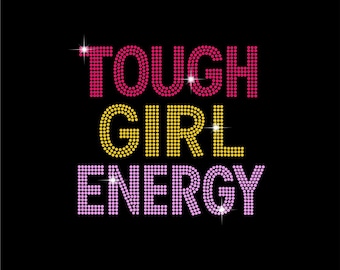 May include: Black background with the words "TOUGH GIRL ENERGY" in a rhinestone-like font. The word "TOUGH" is in pink, "GIRL" is in yellow, and "ENERGY" is in purple. Sparkle accents are visible.