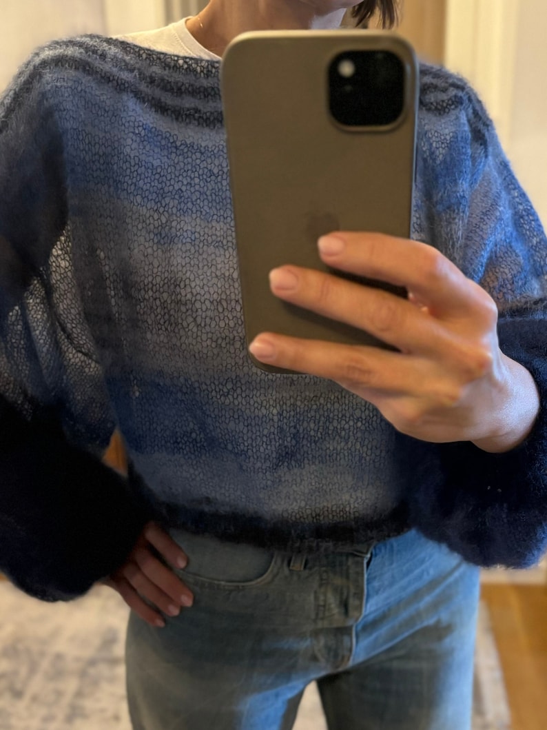 May include: A blue and white ombre knit sweater with a loose fit and long sleeves.