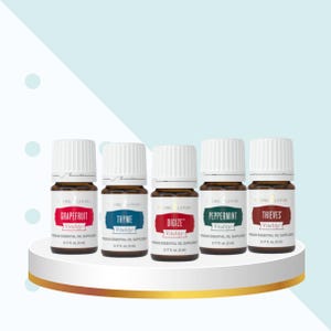 May include: Five 15 ml bottles of Young Living essential oils. The bottles are labelled with the names "Grapefruit", "Thyme", "Digize", "Peppermint", and "Thieves". All bottles are labelled "Vitality" and are arranged in a row on a white surface.