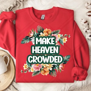 May include: Red sweatshirt with a floral design and the text "Make Heaven Crowded" in green letters.
