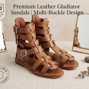 May include: Tan leather gladiator sandals featuring a high-top design with multiple horizontal straps, silver-toned metal buckles, and metallic stud accents. The text Premium Leather Gladiator Sandals | Multi-Buckle Design is visible.