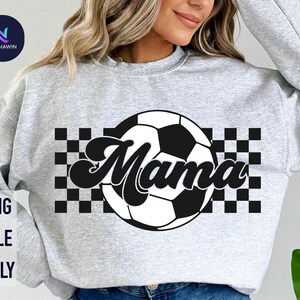 May include: Gray sweatshirt with a black and white checkered design and a soccer ball with the word "Mama" in a retro font.