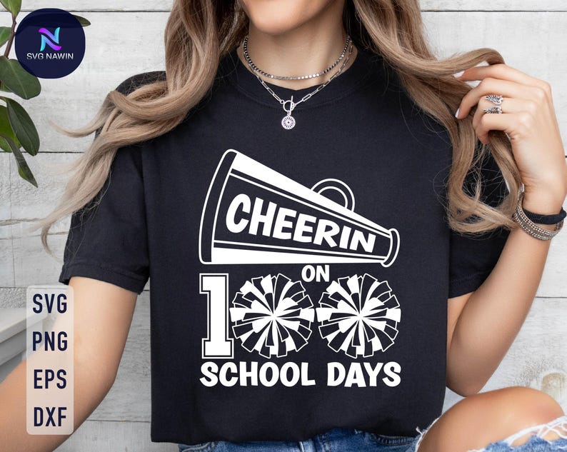 May include: Black t-shirt with a white graphic of a megaphone with the text "Cheer on 100 School Days" and two white cheerleading pom-poms.