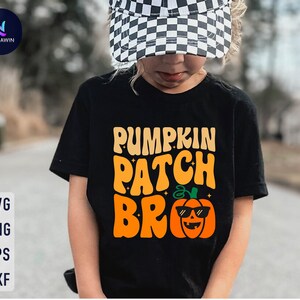 Puede incluir: Una camiseta negra con el texto "Pumpkin Patch Bro" en letras naranja y amarillas. Debajo del texto hay una calabaza de dibujos animados con gafas de sol.