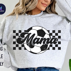 May include: Gray sweatshirt with a black and white checkered pattern and a soccer ball with the word "Mama" in a black and white distressed font.