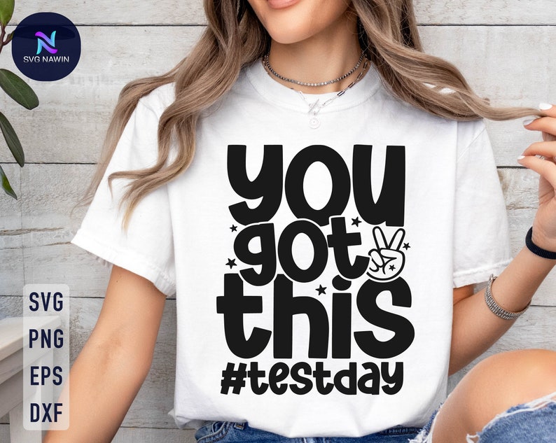 May include: White t-shirt with black text that reads "You got this #testday" with a peace sign graphic.