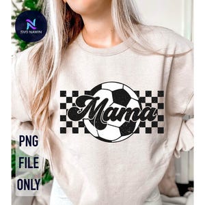 May include: A white sweatshirt with a black and white checkered pattern and a soccer ball with the word "Mama" in a retro font.