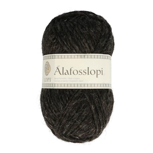 May include: A dark brown ball of Álafosslopi yarn. The yarn is wrapped with a white label that has the brand name and logo. The yarn is thick and appears to be made of wool, perfect for knitting or crocheting projects.