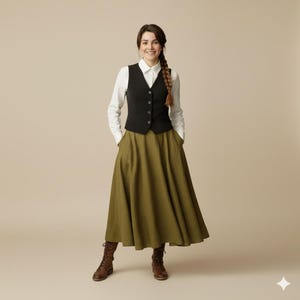 May include: A woman wearing a black vest over a white button-down shirt, paired with an olive green maxi skirt and brown boots. The outfit is a blend of classic and rustic styles, suitable for various occasions.