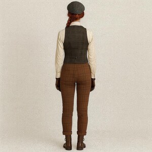 May include: A woman's outfit featuring a tweed newsboy cap, a plaid vest, a button-down shirt, brown plaid pants, and boots. The outfit is in shades of brown, tan, and gray, creating a classic, vintage aesthetic.