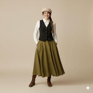 May include: A woman wearing a black vest over a white collared shirt, paired with an olive green skirt and brown boots. She is also wearing a beige cap. The outfit is a mix of classic and rustic styles.