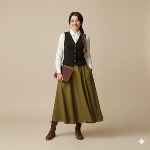May include: A woman wearing a black vest over a white button-down shirt, paired with an olive-green maxi skirt and brown boots. She holds a burgundy book. The outfit has a vintage, classic style.