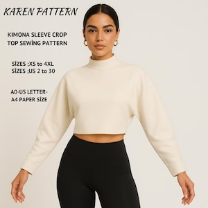 May include: Cream-colored, long-sleeved crop top with a high neckline, paired with black leggings. The image includes text: "KAREN PATTERN", "KIMONA SLEEVE CROP TOP SEWING PATTERN", "SIZES ;XS to 4XL SIZES ;US 2 to 30", and "AO-US LETTER- A4 PAPER SIZE".