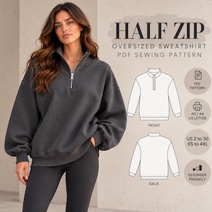 May include: A charcoal gray oversized half-zip sweatshirt with long sleeves and a silver zipper. The image includes text reading HALF ZIP OVERSIZED SWEATSHIRT PDF SEWING PATTERN, along with technical line drawings of the front and back views.