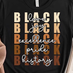 May include: Black t-shirt with the words "Black love", "Black joy", "Black excellence", "Black pride", and "Black history" stacked vertically in brown and tan lettering.