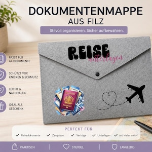Könnte beinhalten: Eine graue Filz-Dokumentenmappe mit dem Text "REISE unterlagen" in Schwarz und Pink, einer Grafik eines roten Reisepasses mit Reisedokumenten sowie einem schwarzen Flugzeugsymbol mit einer gestrichelten, herzförmigen Flugroute.