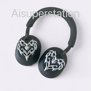 May include: Black over-ear headphones with a silver heart-shaped design on each earcup. The headphones have the word "SONY" printed on the side.