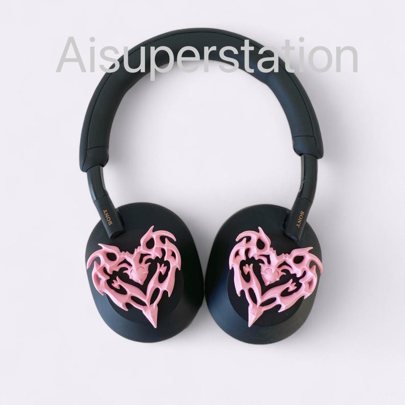May include: Black over-ear headphones with pink heart-shaped designs on the earcups. The headphones have the word "SONY" written on the side.