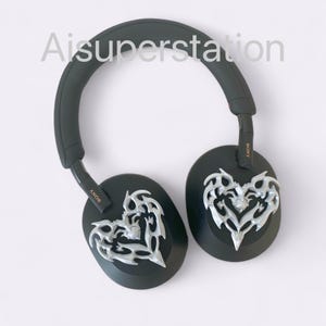 May include: Black over-ear headphones with silver heart-shaped designs on the earcups. The headphones have the word "SONY" printed on the side.