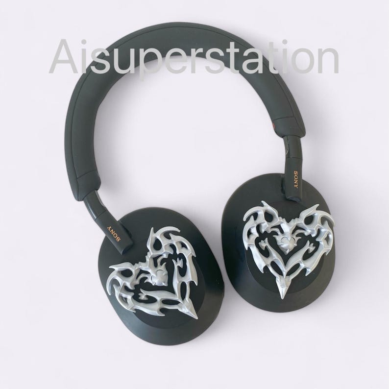 May include: Black over-ear headphones with silver heart-shaped designs on the earcups. The headphones have the word "SONY" printed on the side.