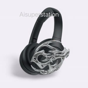 May include: Black over-ear headphones with a silver decorative design on one earcup. The design resembles a stylized branch or vine.