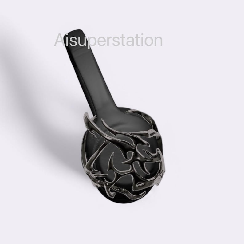May include: Black headphones with a decorative, intricate design on the earcups. The design is reminiscent of a stylized floral pattern.