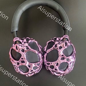 May include: Purple headphones with a unique, textured design. The headphones have a black headband and earcups.