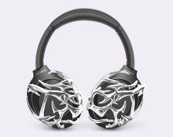 May include: Black over-ear headphones with a silver, intricate, geometric design on the earcups. The headphones have the word "SONY" printed on each earcup.