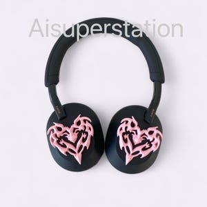 May include: Black headphones with pink heart-shaped ear covers with a tribal design. The headphones have the word "SONY" written on the side.