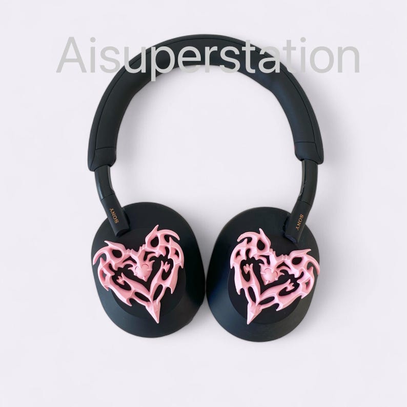 May include: Black headphones with pink heart-shaped ear covers with a tribal design. The headphones have the word "SONY" written on the side.