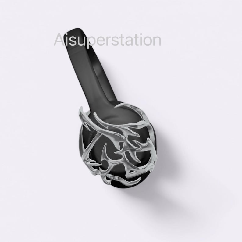 May include: Black headphones with a silver, intricate, thorny design on the earcup. Aisuperstation is printed on the headband.