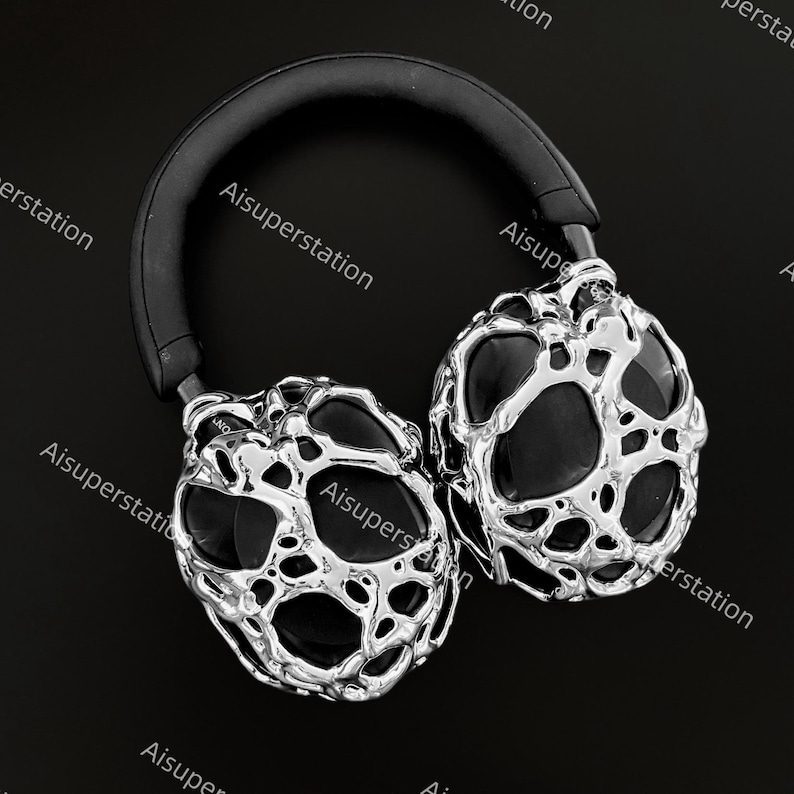 May include: Silver headphones with a black headband and a unique, textured, organic design. The headphones have a futuristic, modern look.