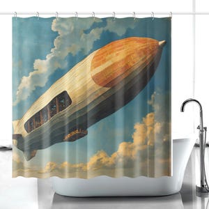 May include: A shower curtain featuring a vintage illustration of a zeppelin airship soaring through a cloudy blue sky. The airship is primarily beige and orange, with a dark gray underside. The design evokes a retro, aviation theme.