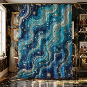 May include: A blue and teal shower curtain with a wavy, abstract design. The pattern includes silver and gold accents, creating a luxurious, water-like effect. The curtain is hanging in a bathroom with black marble flooring.