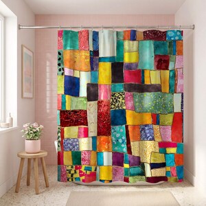 May include: A shower curtain featuring a vibrant, multi-colored patchwork design composed of various rectangular and square shapes. The pattern includes shades of red, yellow, blue, green, orange, and purple, with thin gold lines separating each block.