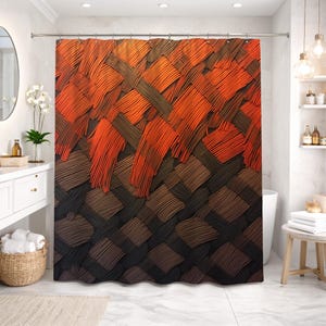 May include: A shower curtain with a woven pattern in shades of orange, brown, and black. The design features a textured, overlapping weave, creating a gradient effect from top to bottom. The curtain hangs from a silver rail in a bathroom setting.