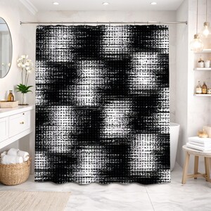 May include: Black and white shower curtain with a textured, abstract design. The pattern features a mix of brushstroke-like shapes and grid-like elements, creating a modern and artistic look. The curtain is hanging in a bathroom setting.